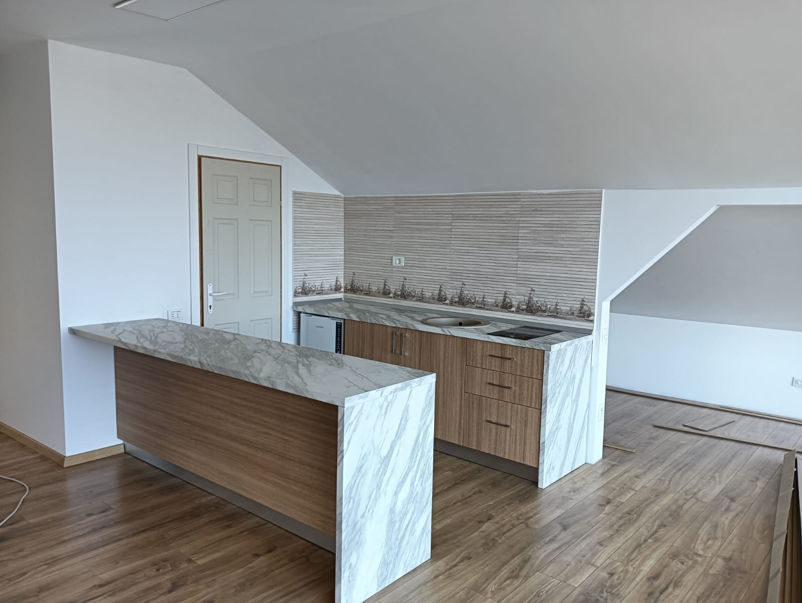 Bucătărie cu bar și blat cu aspect de marmură